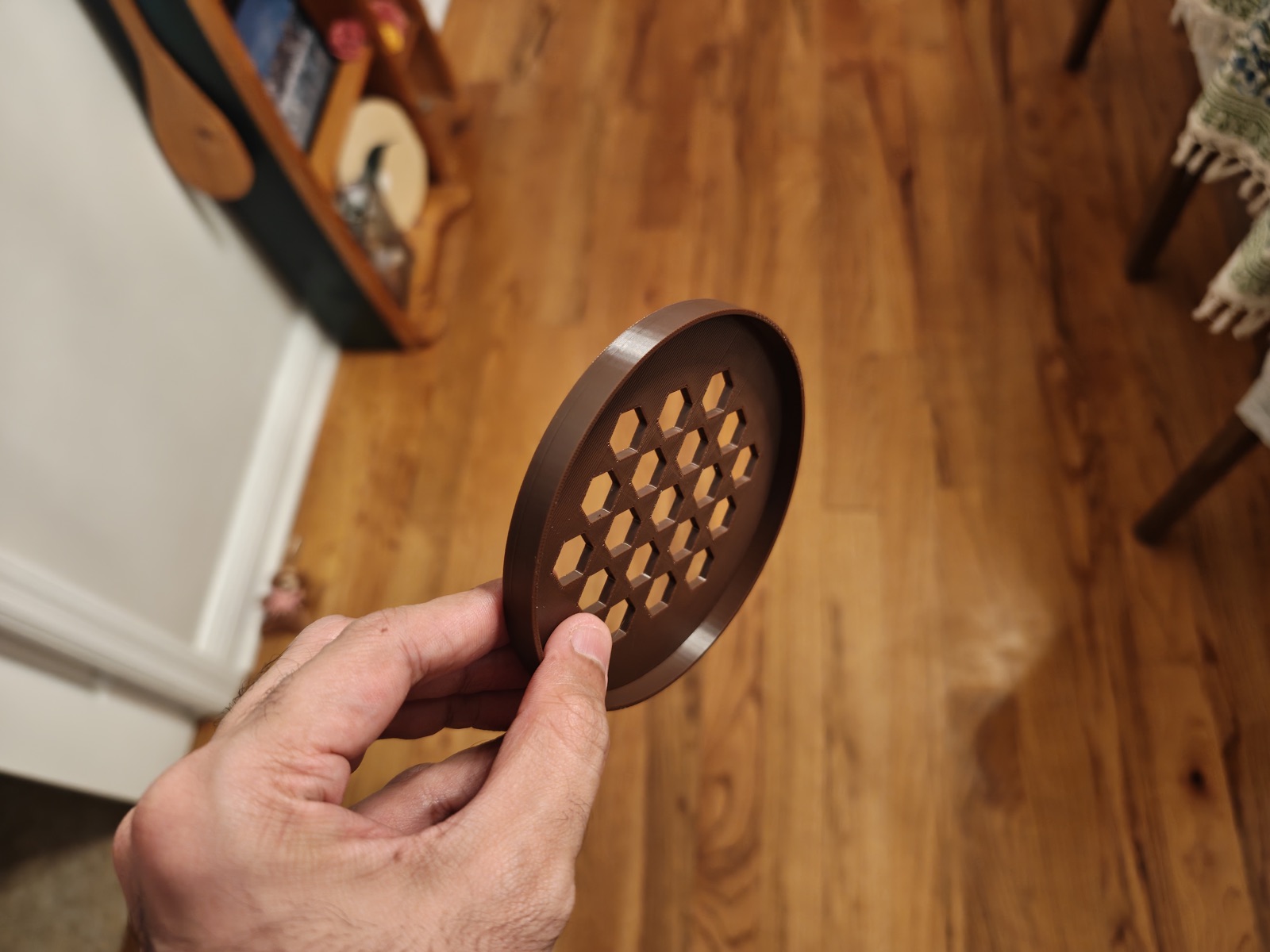 Brown lid with a hexagonal vent pattern